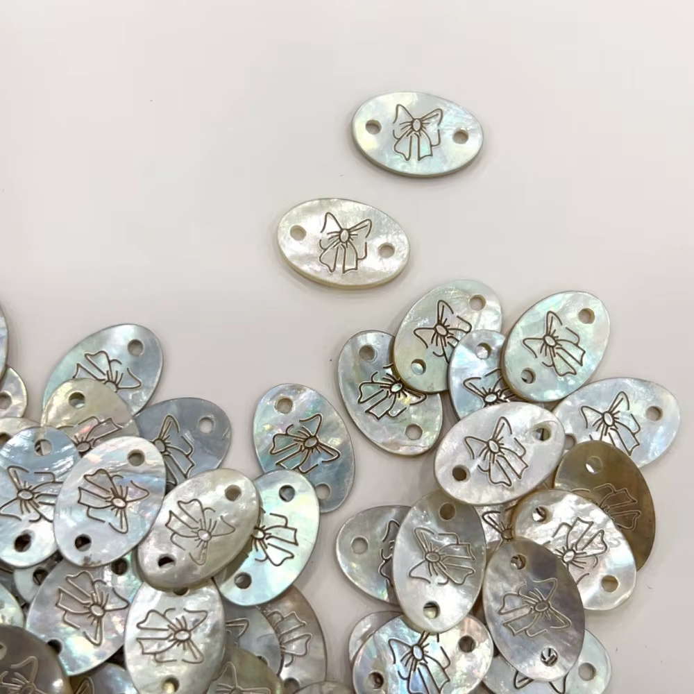 Bouton d'étiquette en coquillage exquis avec motif d'arc pour bricolage de T-shirts
