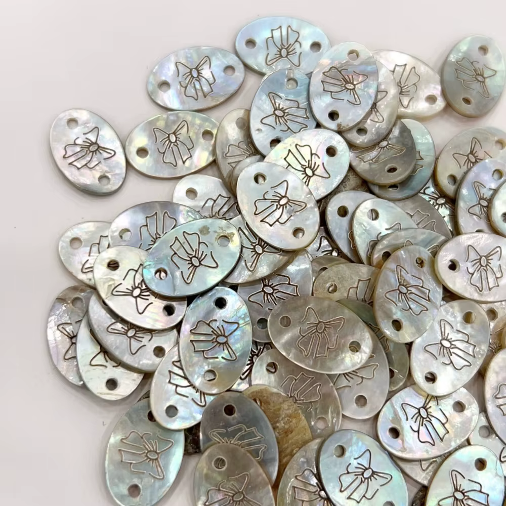 Bouton d'étiquette en coquillage exquis avec motif d'arc pour bricolage de T-shirts