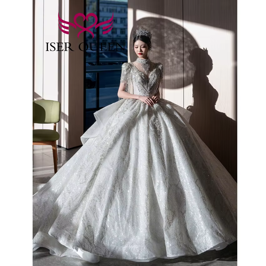 Robe de mariée de luxe personnalisée, nouvelle tendance 2026, pour femme, col montant, manches à franges, perles lourdes, robes de mariée scintillantes WX0474